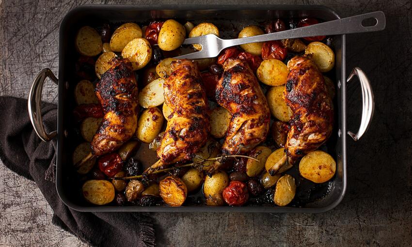 cooked chicken traybake with harissa, olives & potatoes