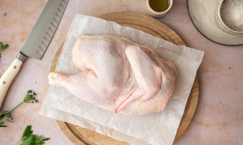 half chicken on resting board 