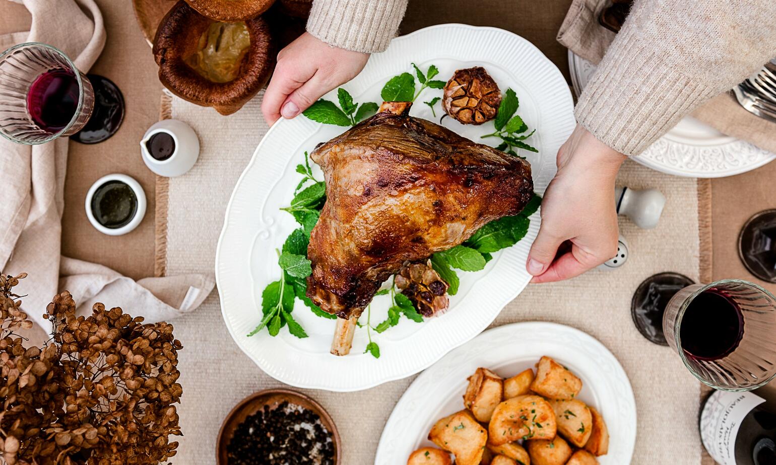 lamb roast dinner with side potatoes 