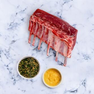 rack of lamb with herb crumb on marble background