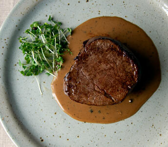 fillet steak with black peppercorn sauce cooked